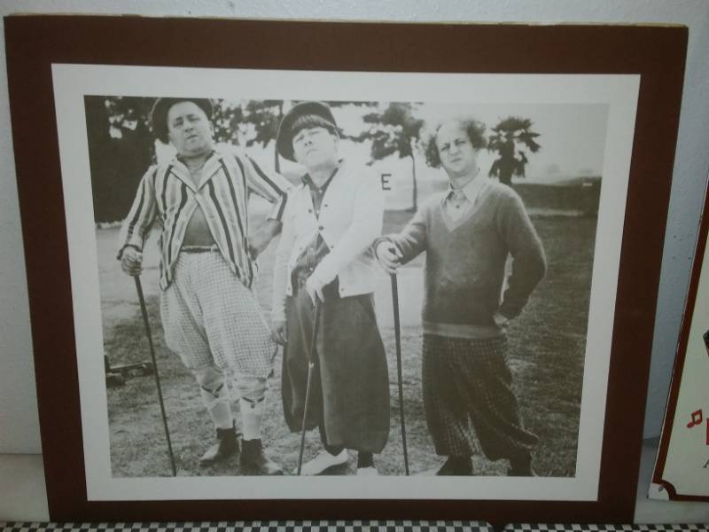 lot 108 image: 4 metal signs and Three Stooges print.