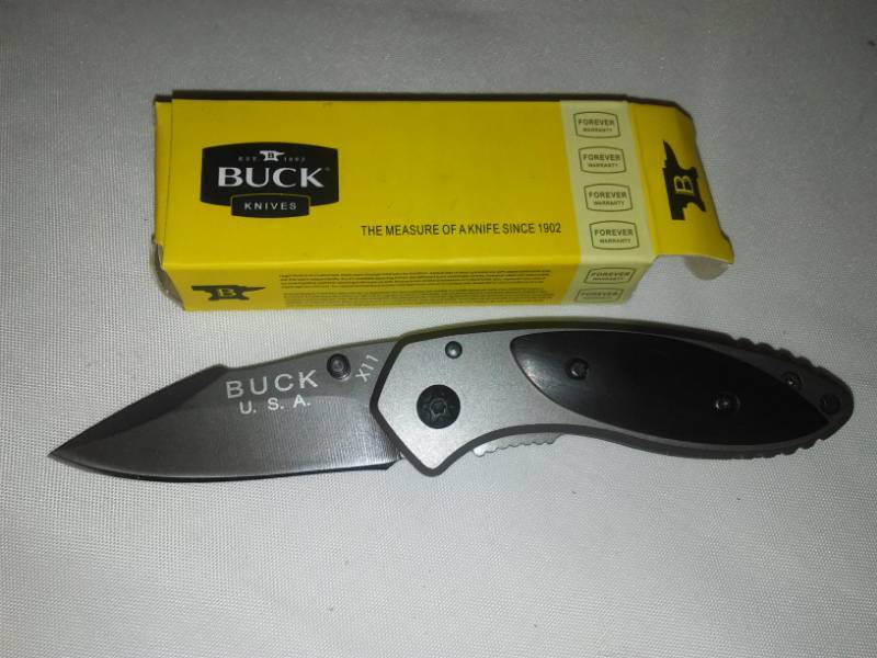 lot 113 image: Folding buck knife. Model X11. New with box,