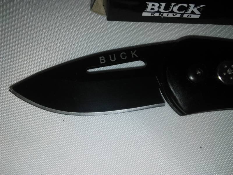 lot 114 image: Folding buck knife, black  New in box,