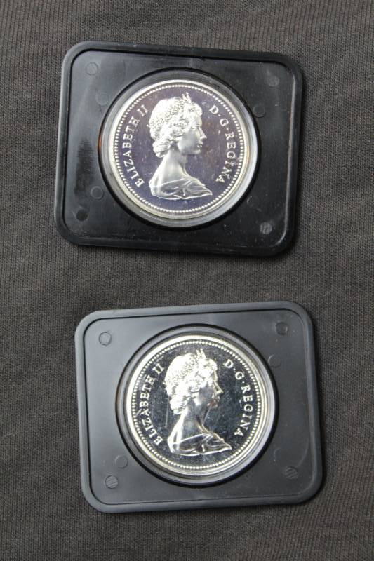 lot 36 image: Lot of (2) Specimen Canadian $1.00 Silver Dollar in Mint Sealed Acrylic CasesLot of (2) Specimen Canadian $1.00 Silver Dollar in Mint Sealed Acrylic Cases, Includes(1) 1974 Winnepeg and (1) 1975 Calahry Centennial Specimen Silver Dollar Coins, Ungaded
