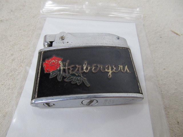 lot 106 image: Vintage HERBERGERS Advertising Cigarette Lighter