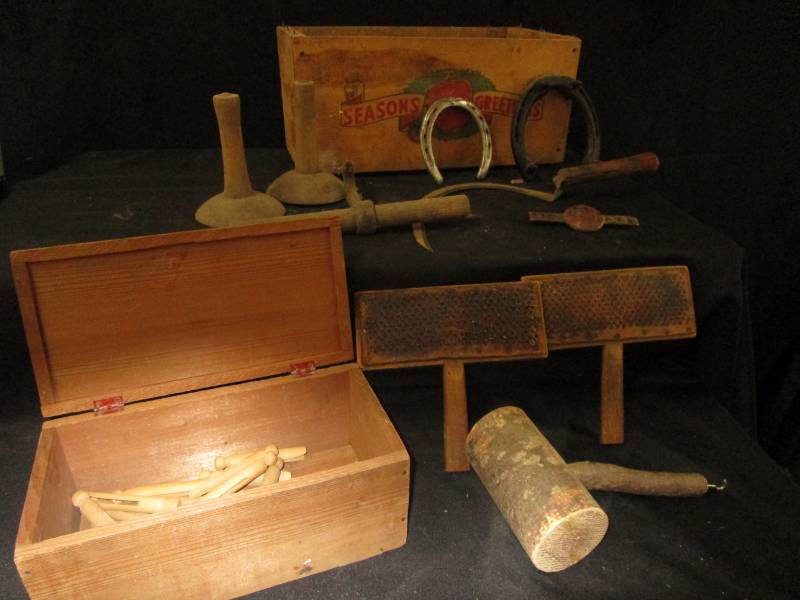 lot 24 image: Pig scapers, old clothes pins, wool tools, hook, horse shoes and old wood boxes
