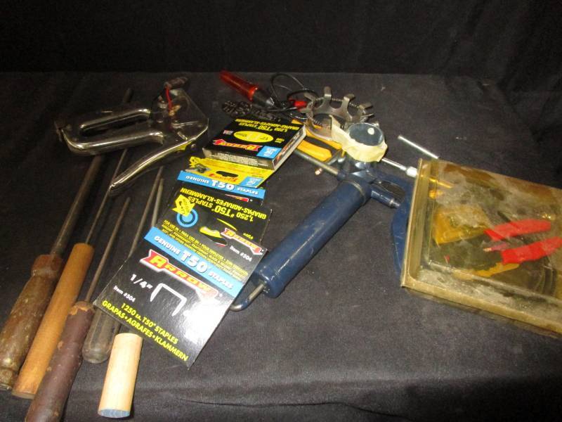 lot 28 image: Stapler with extra staples, Shapner, files, greese gun, wire strippers , test light, and various items