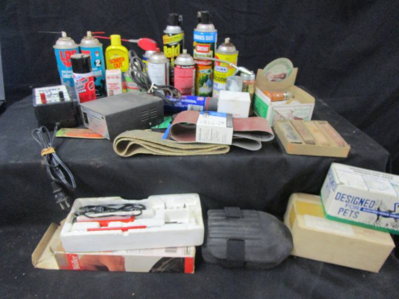 lot 39 image: patches, glue, WD40, silicone, bug spray, raid, electronic cleanerLPS greasless lubricant, funnel, sand paper, soldering iron, speedy leather sticher, mini electric fencer model and knee pads  k-9 , 12 volt power supply 110-112