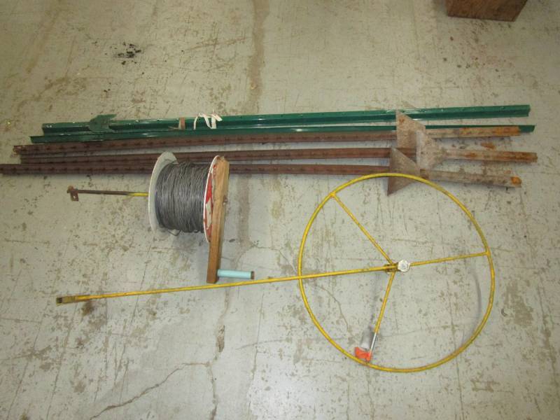 lot 82 image: Fencing posts, measuring wheel and wire spool