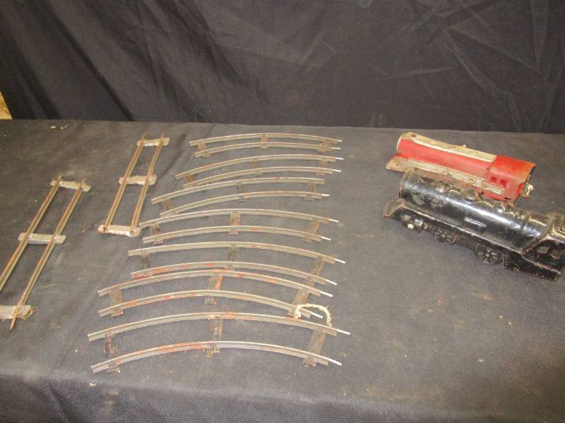 lot 141 image: Antique steel wind-up model train and some track sections.  Not tested