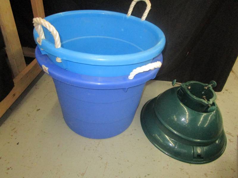 lot 148 image: 10 tall tree stand and two large plastic tubs
