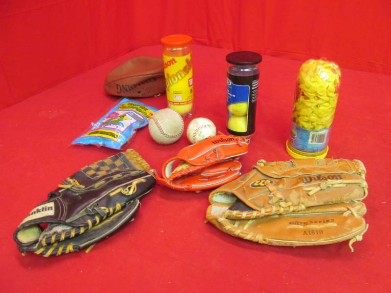 lot 132 image: Baseball gloves (Franklin and Wilson), tennis balls, water balloons, Spalding Football