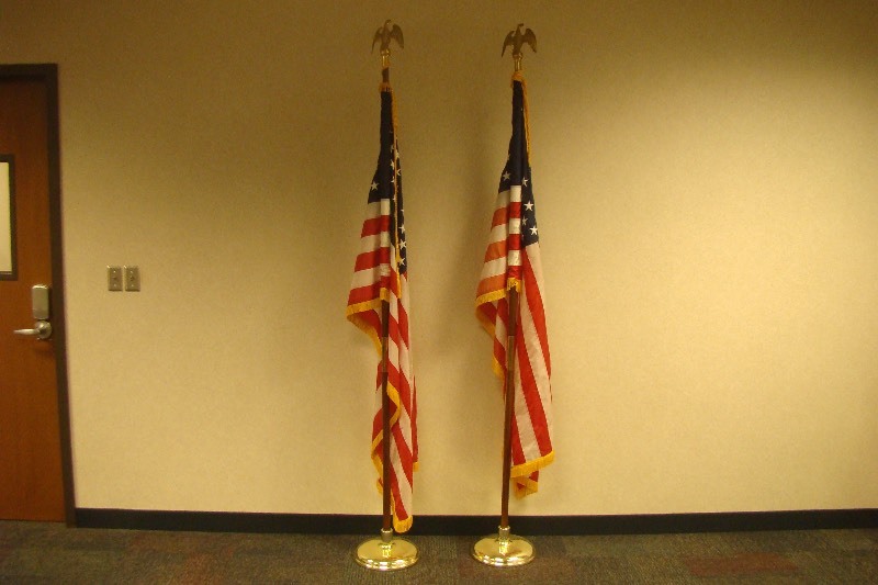 lot 1 image: 2 US Flags on Wood Poles in Heavy Bases