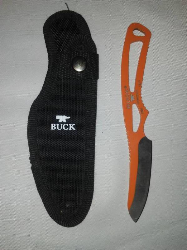 lot 62 image: Buck knife with belt sheath.