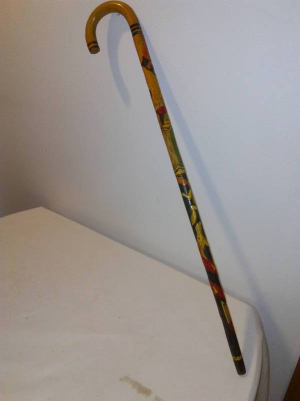 lot 136 image: Hand carved cane - wood stained, 35.5 inches long.