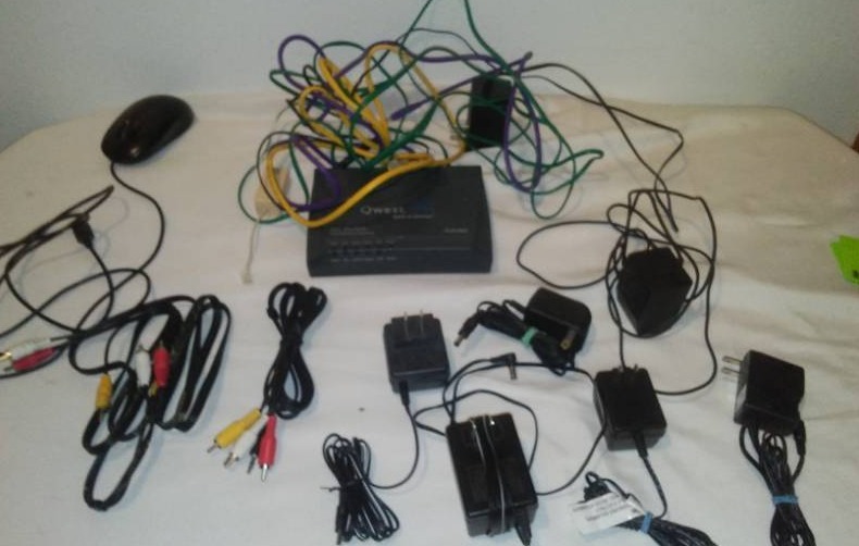 lot 182 image: Misc. Internet and computer power cords, wired mouse, Qwest Modem with cords.