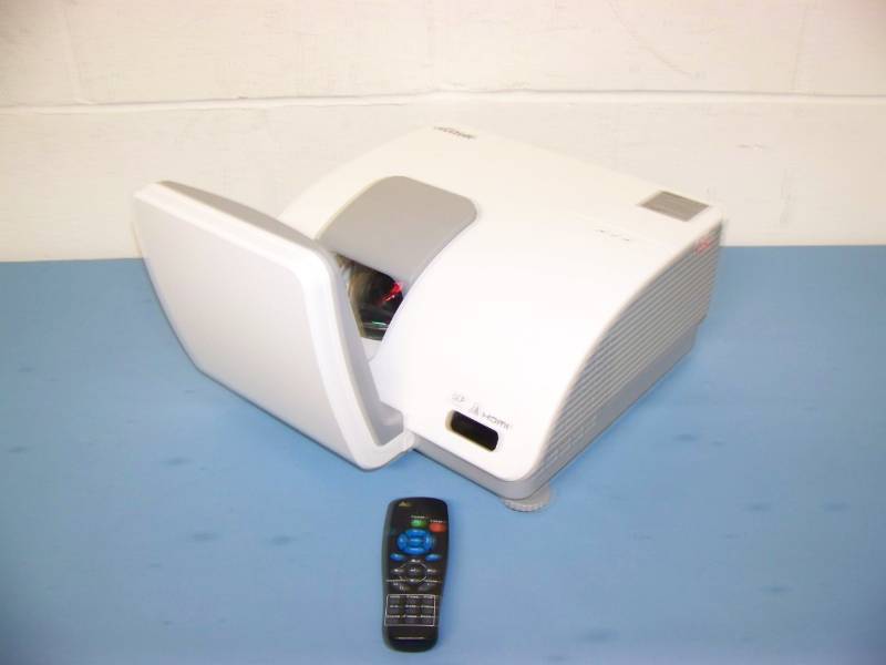 lot 1 image: Vivitek, DLP, Super Short Throw Projector with HDMI Input, Remote Control, (8) NEW Digital Decoration Holiday  Celebration DVDs and (2) NEW Projection Materials (Window and Hologram)