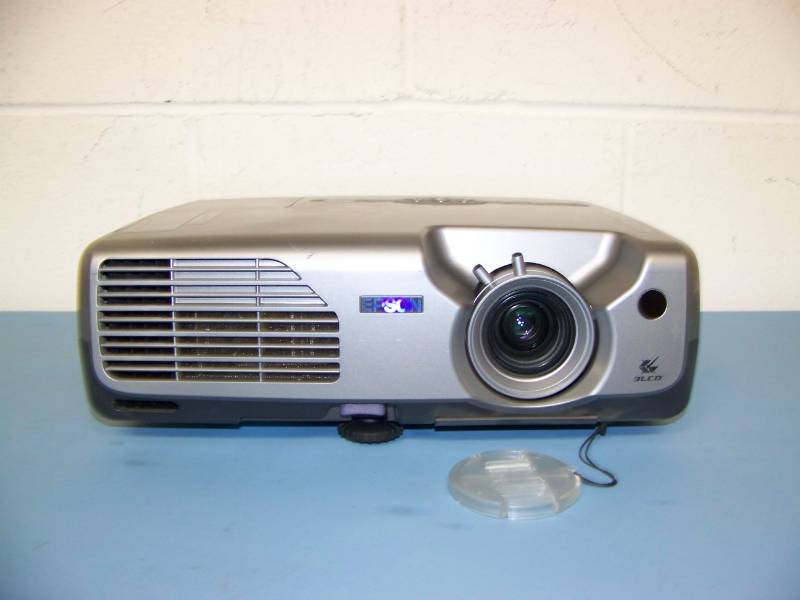 lot 7 image: Epson, PowerLite, LCD Projector with (8) NEW Digital Decoration Holiday  Celebration DVDs and (2) NEW Projection Materials (Window and Hologram)