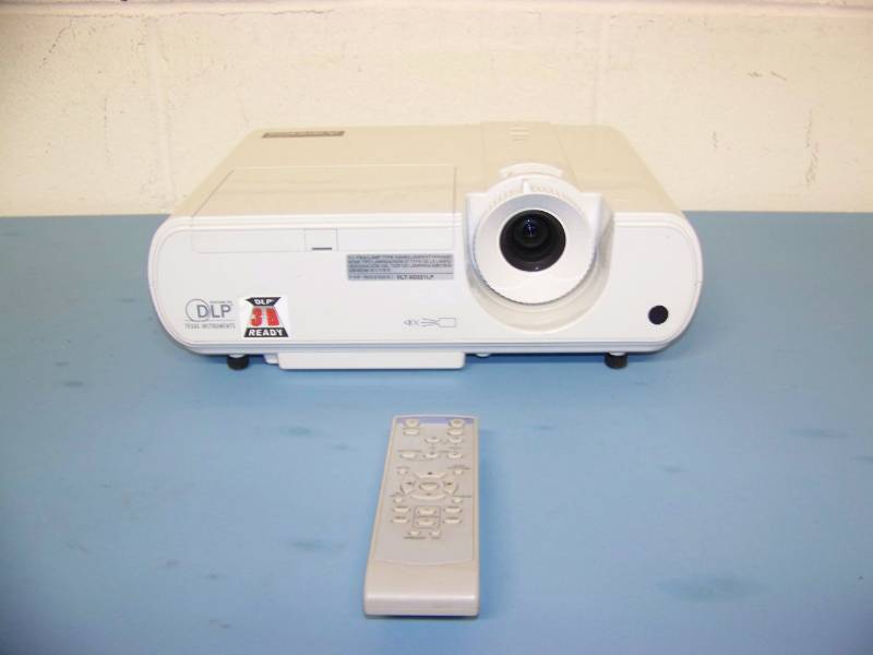 lot 6 image: Mitsubishi, DLP Projector with Remote Control, (8) NEW Digital Decoration Holiday  Celebration DVDs and (2) NEW Projection Materials (Window and Hologram)