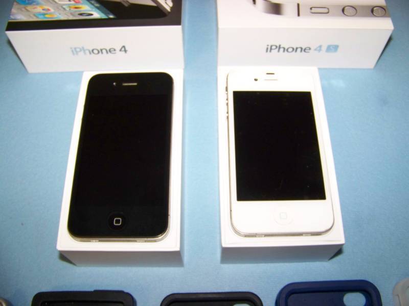 lot 119 image: (1) Apple iPhone 4 and (1) Apple iPhone 4S with Original Boxes, Phone Cases and Charging Cables