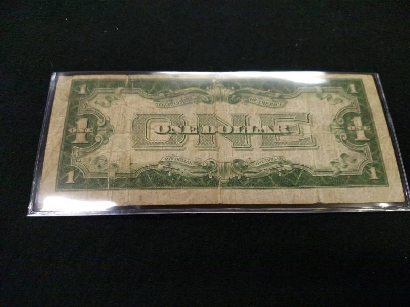 lot 59 image: 1928 B Funny Back One Dollar Silver...