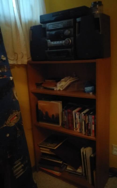 lot 56 image: Wood Shelf 28x12x48 & Contents JVC Stereo, DVDs, Books, Misc