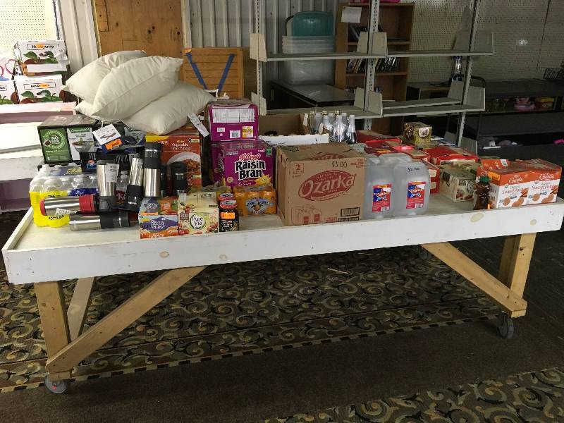 lot 275 image: TABLE OF MISC FOOD, WATER BOTTLES, AND PILLOWS