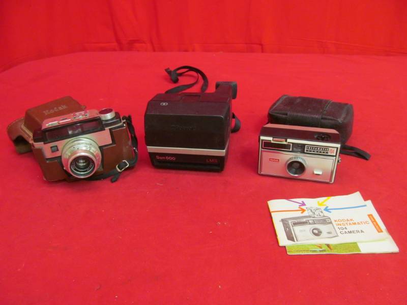 lot 14 image: Kodak camera (instamatic camera 104), Polaroid Sun 600 LMS, Kodak Signet 50 camera