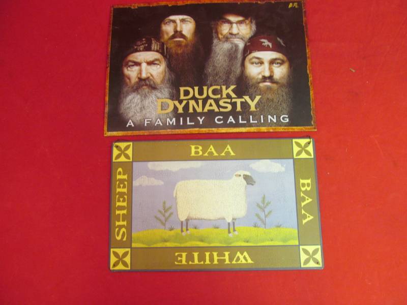 lot 23 image: 2 metal signs (17x16), (16x10), Duck Dynasty and Baa White Sheep