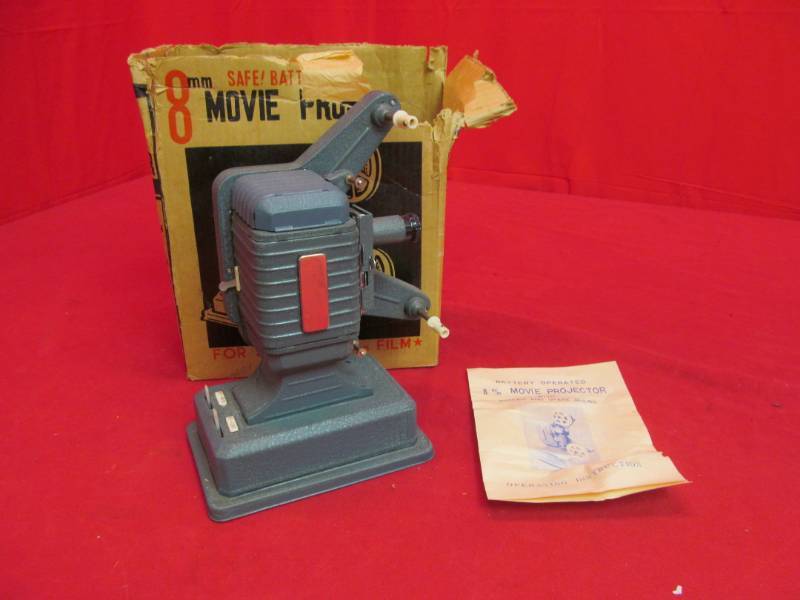 lot 83 image: Battery operated 8 mm movie projector with screen