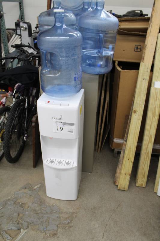 lot 19 image: Primo HotCold Water Dispenser w 8 5-Gallon Plastic Water Bottles