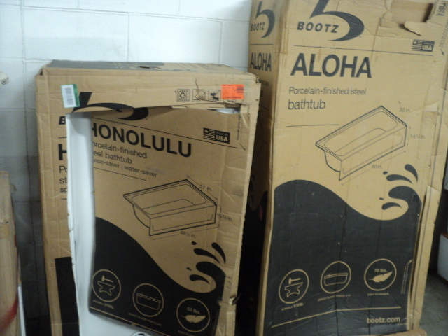 2 bathtubs - larger one has a small...