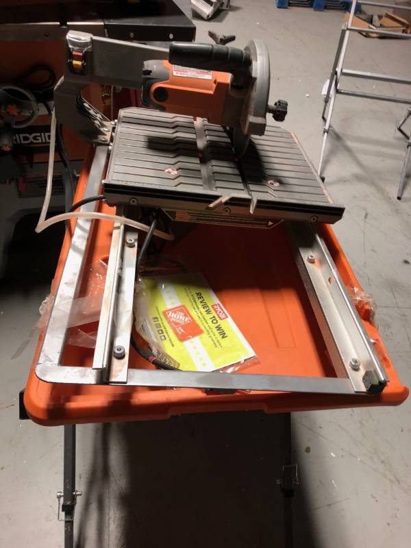 lot 104 image: Ridgid 120-Volt 7 in. Tabletop Wet Tile Saw with Stand in good working conditions not used