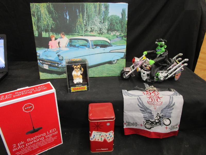 lot 21 image: Motorcycle watch with leather band, Canvas Chevy Car Picture, Born to be Wild , Bad Taste Bears, Games, 2 Pk Flashing Lead Auto Parking Signals, and Hankie with Motorcycle on it