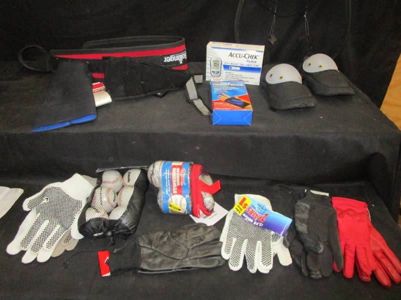 lot 33 image: back braces, knee braces, theraphy hand brace, new baseballs, unused gloves, acucheck unopened, knee braces and more
