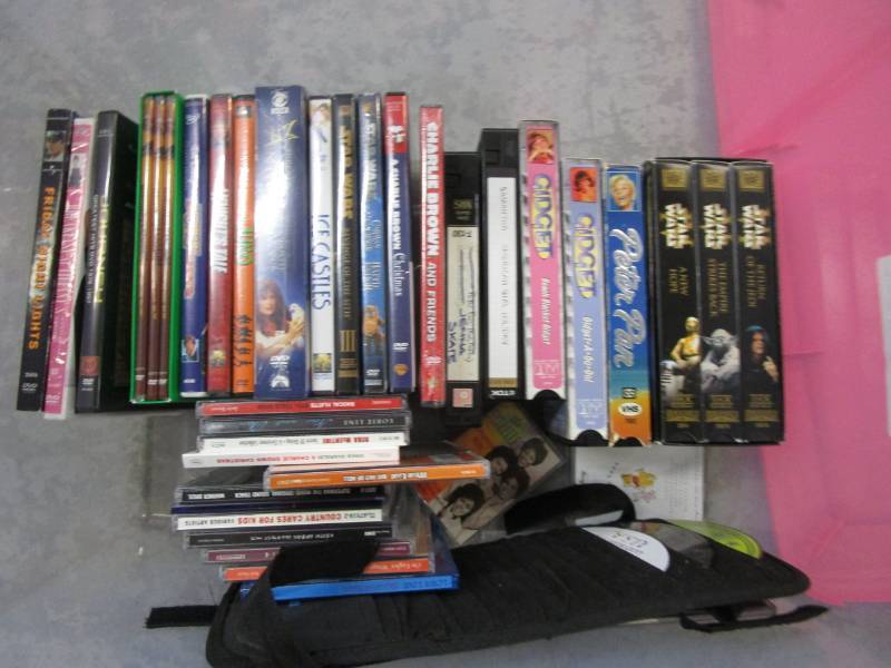 lot 83 image: Lots of DVDs Movies, Friday night lights, star wars, CDs, lots unopened, in a tub