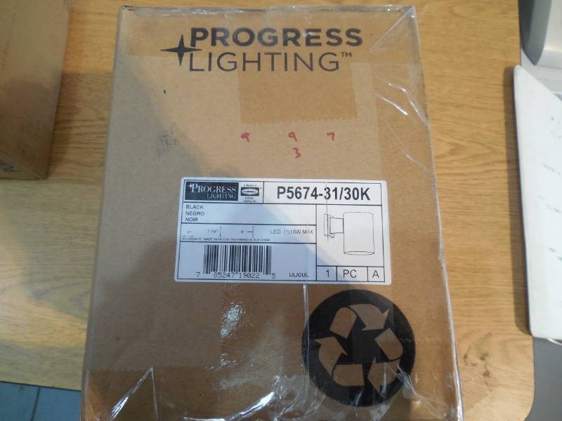 lot 8 image: Progress Lighting 1-Light Black Integrated LED Outdoor Wall Mount Cylinder Light