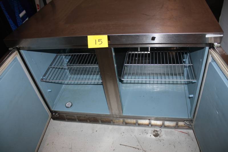 lot 15 image: Delfield, Mod #UC4048, two door under counter refrigerator, NSF, caster mounted, 115 volts, 5 amps, 48x28x33H-1Runs Cools