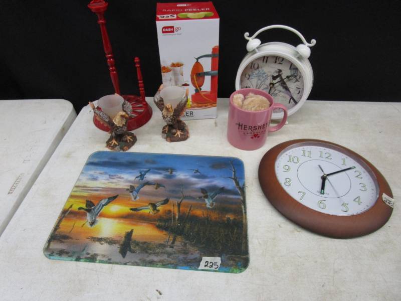 lot 91 image: Eagle candle holders, clocks, herseys mug, apple peeler, chicken paper towel holder metal and Cutting board