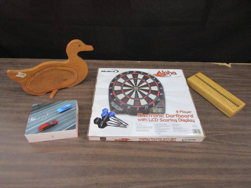 lot 105 image: Electronic Dart Board, Cribbage Board, Wood Carved Duck, HUM by Verizon