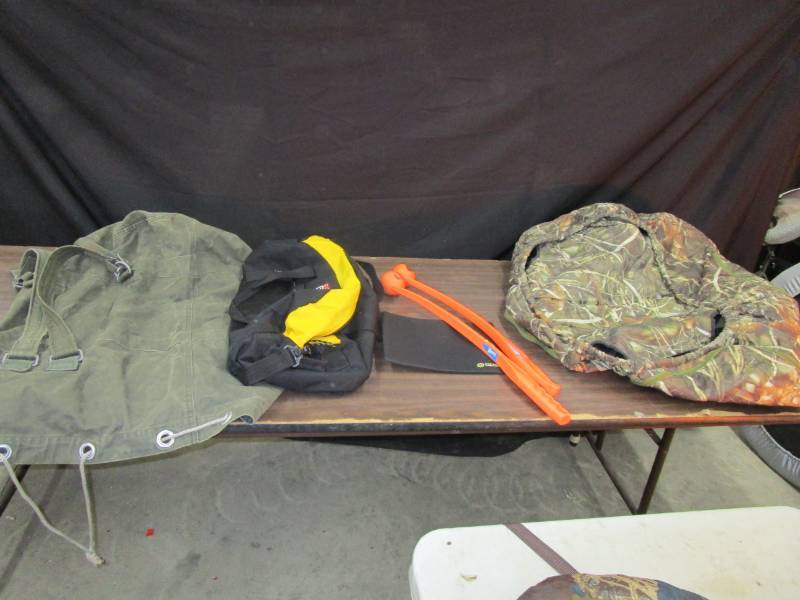 lot 123 image: Military bag, ball throwers, we think it a unused kennel cover and more
