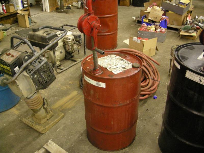 lot 249 image: Empty 30gallon Oil Barrel and pump