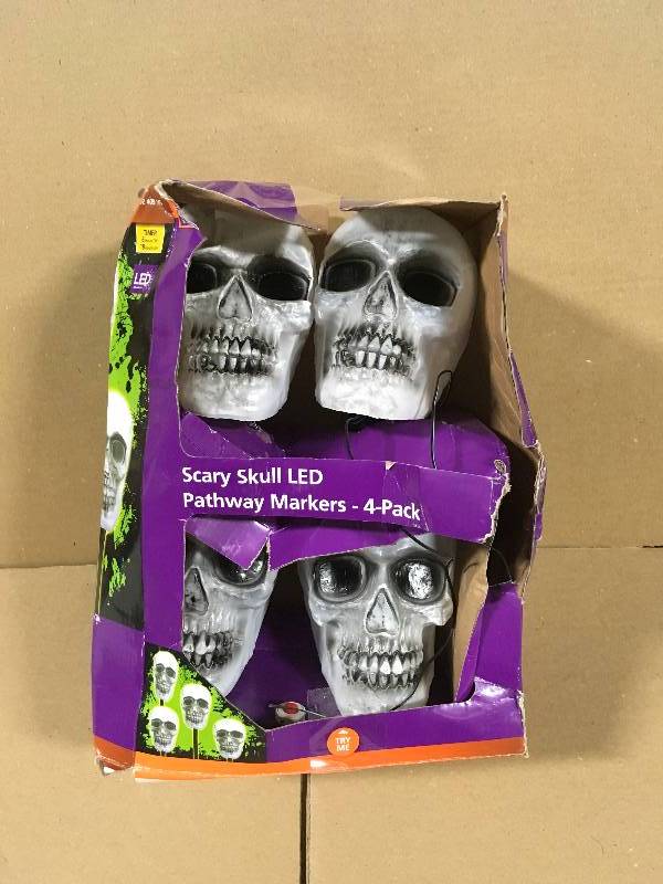 lot 105 image: Home Accents Holiday 14-12 in. Blow Molded Skull Pathway Markers with LED Illumination (4-Set)