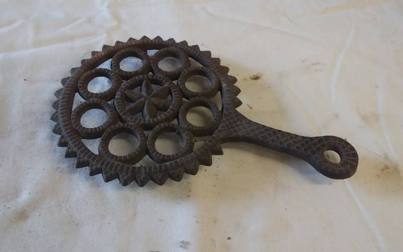lot 16 image: Griswold Cast Iron Trivet - 9 Inch