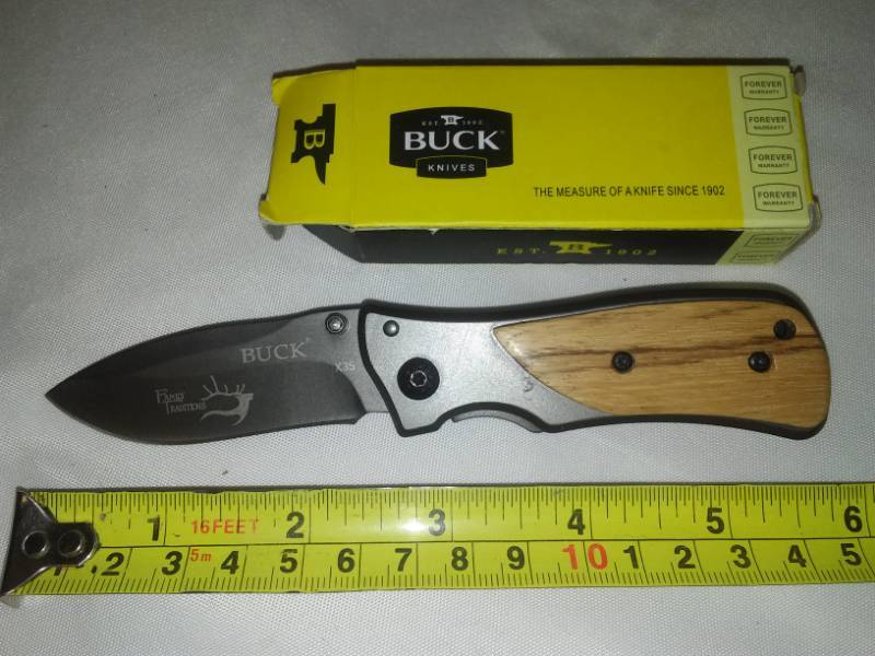 lot 26 image: Buck knife foldable pocket knife, real wood grain handle.