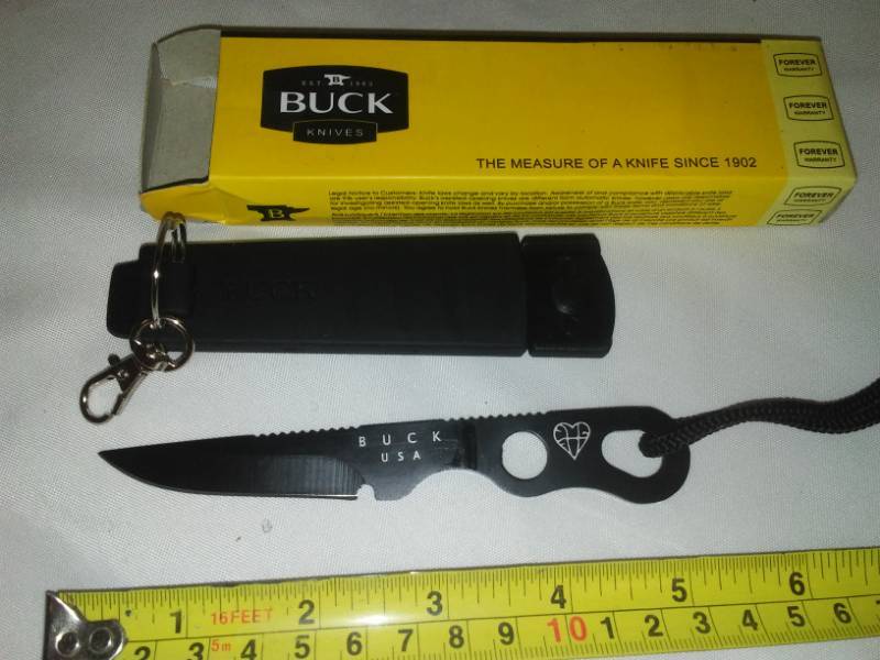 lot 27 image: Buck knife pocket knife with holder belt clip.