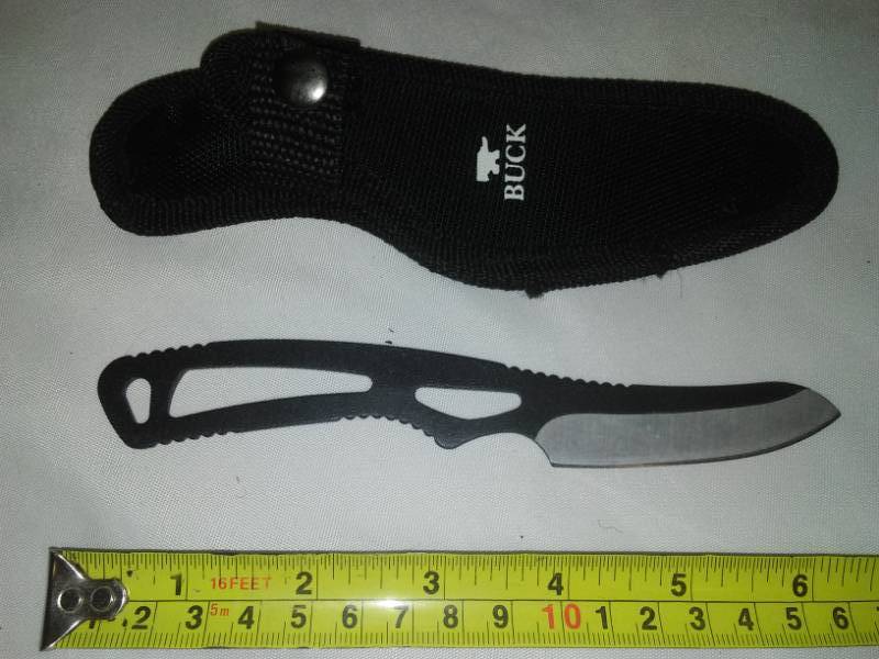 lot 31 image: Buck knife foldable pocket knife in nylon belt sheath.