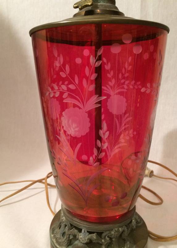 lot 49 image: Antique Cranberry Etched Art Glass Lamp - Has 2 hairline cracks that go up a 3rd of the lamp.  Hard to see but there are pictures of it.  This is a very old lovely lamp and still works