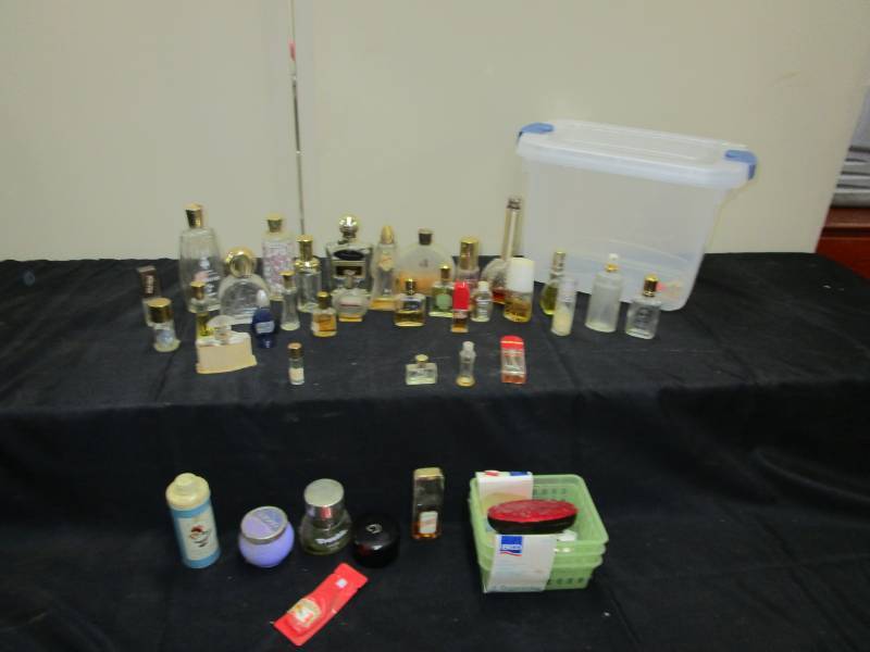 lot 14 image: Old perfume bottles and tub