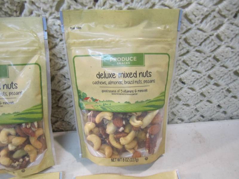 lot 112 image: 4 Bags of Deluxe Mixed Nuts Best by...