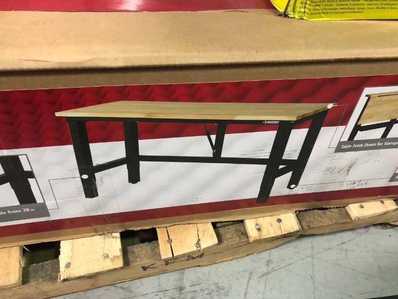 lot 93 image: Husky 42 in. H x 72 in. W x 24 in. D Steel and Wood Folding Adjustable Height Garage Workbench in Black in good conditions