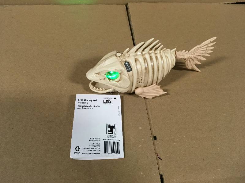 lot 124 image: Home Accents Holiday 4 in. Animated Swimming Piranha with LED Illuminated Eyes in good conditions