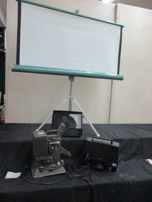 Two projectors, Keystone model R-8, Daf Model 166Z along with a projector Screen