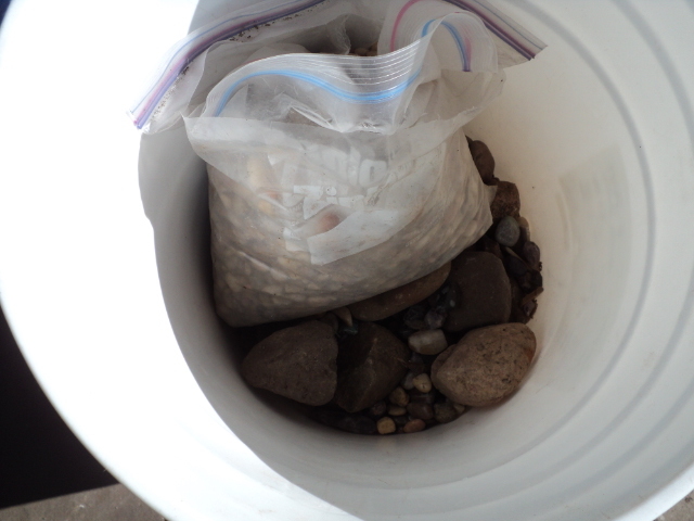 lot 9 image: pail of small stones...
